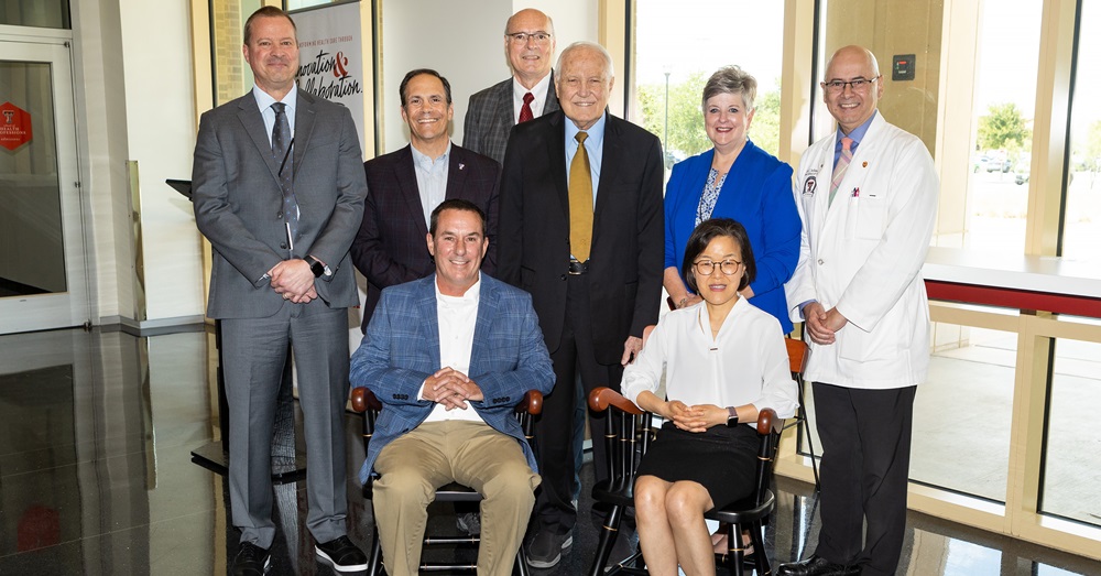 group photo of people sitting and standing