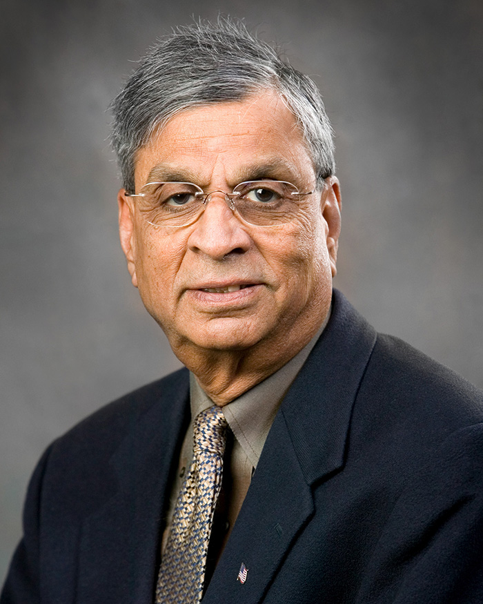Surendra Varma, M.D., wears a suit and tie.