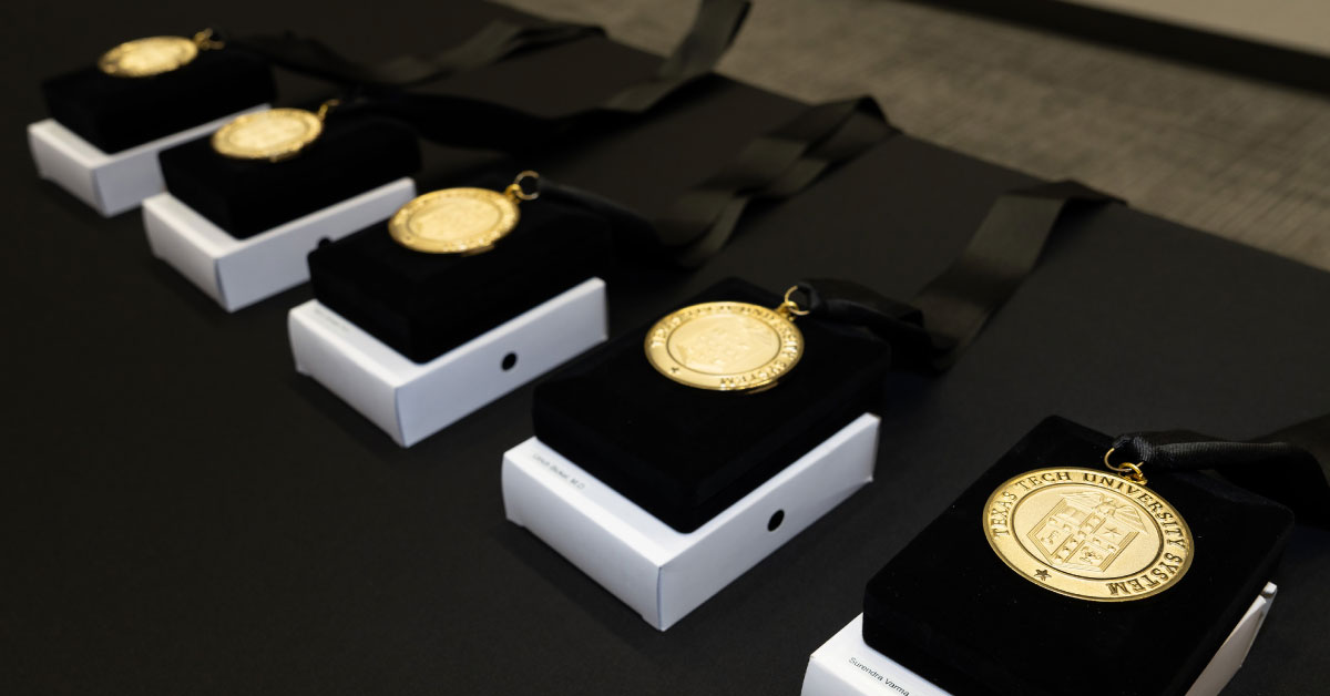 Several gold medallions sit on a table.