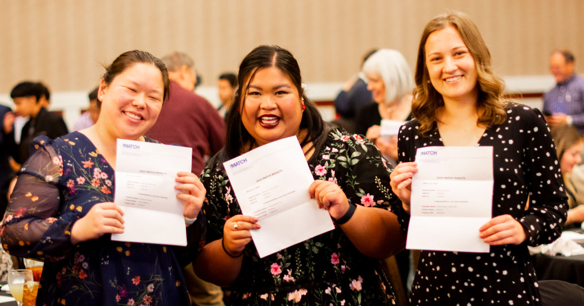 Three female TTUHSC medical students hold up their match letters.