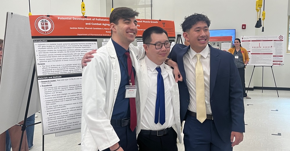 three TTUHSC students smile in front of their poster for the Amarillo Research Symposium