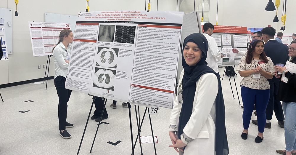 woman standing in front of a research presentation poster