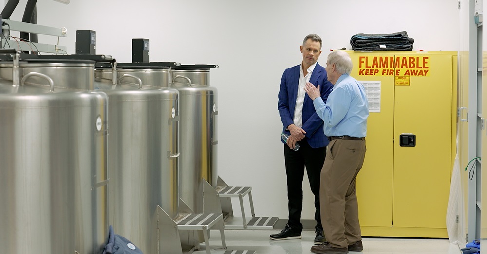 two men observe a research facility