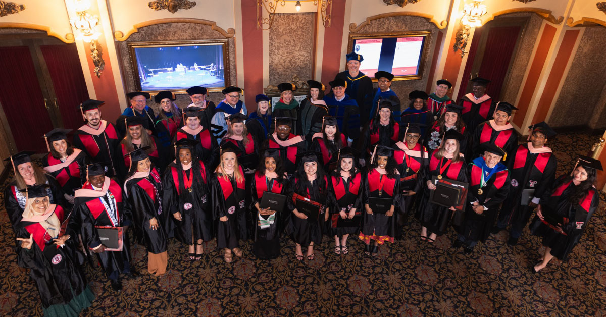 Large group of TTUHSC public health graduates pose for a group photo.