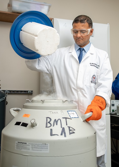 Muhammad Bilal Abid, M.D., working in a lab