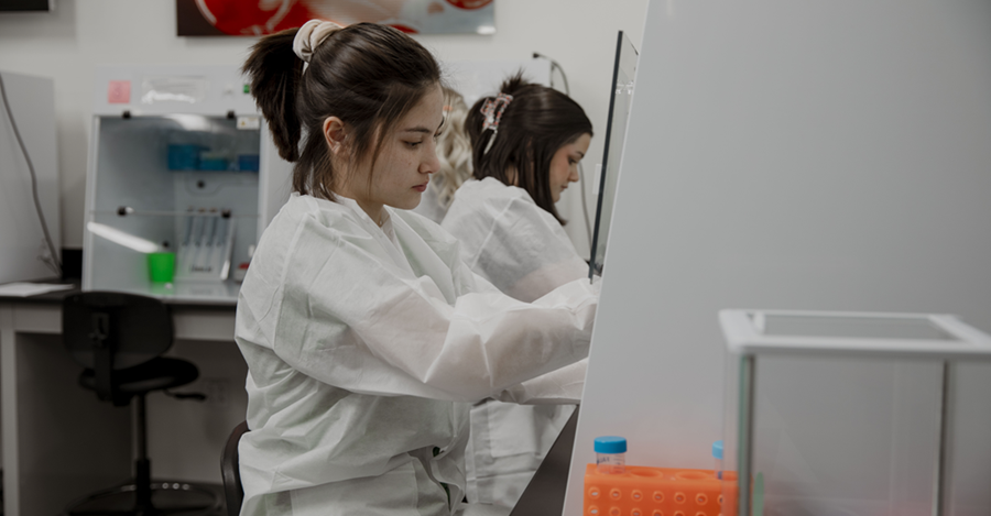 woman working in lab wearing a white coat