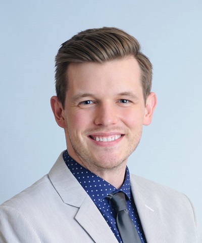 man smiling in his headshot 