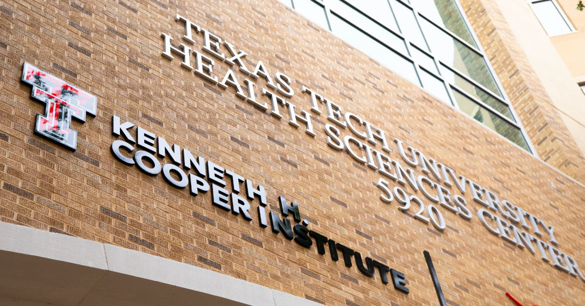 Signs on a brick wall that read, "Texas Tech University Health Sciences Center" and Kenneth H. Cooper Insitute."