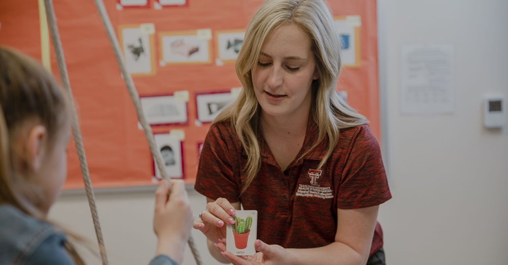 health care professional using flashcards with child