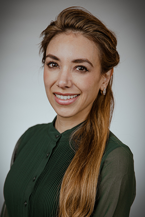 Karla Daniele, M.D., smiles for a studio headshot