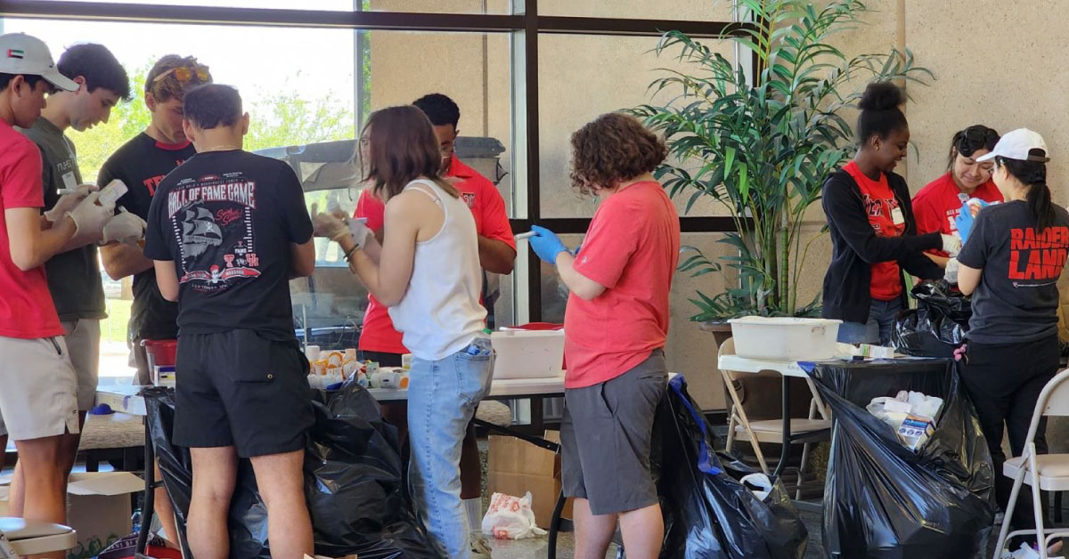 Volunteers sort medications.